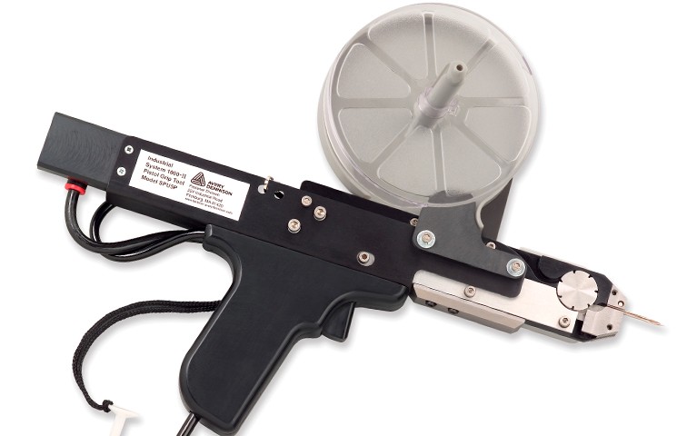 System 1000® Industrial Pneumatic Tool attaching purple tag to a pineapple